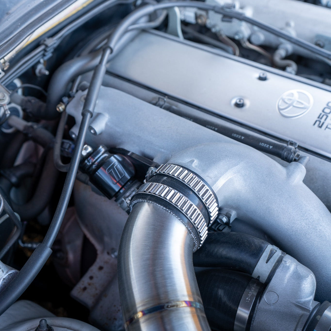 Close-up of a car engine with a focus on the air intake system.